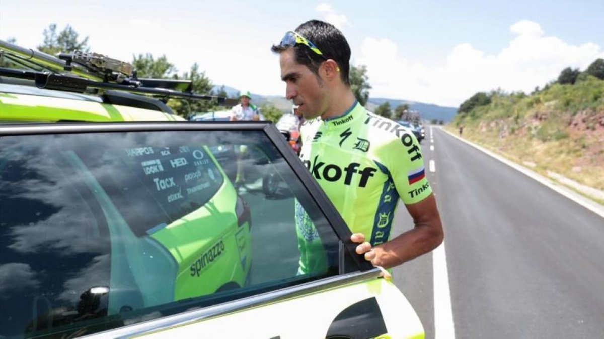 Alberto Contador sube al coche del Tinkoff tras retirarse del Tour en el transcurso de la novena etapa.-AFP / KENZO TRIBOUILLARD