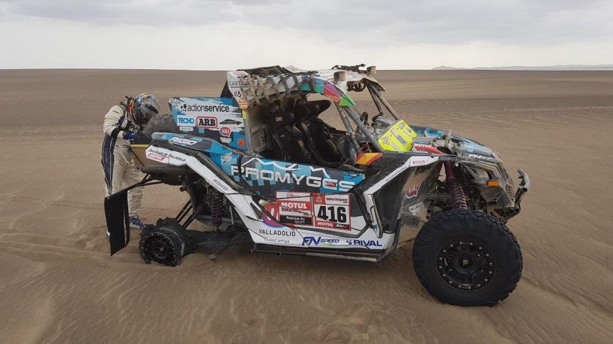 El piloto repara su vehículo tras la etapa.-DUDA BAIRROS / PHOTOSDAKAR.COM