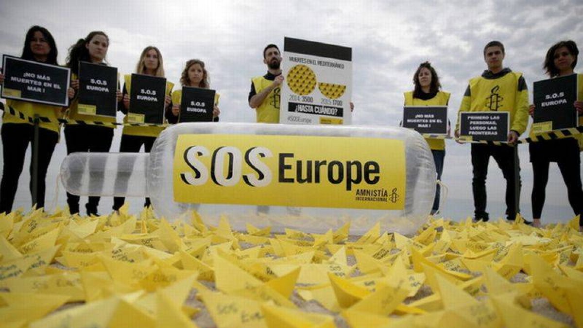 Activistas de Amnistía Internacional denuncian en la playa de Sant Sebastià de Barcelona las muertes de migrantes en el Mediterráneo.-Foto: EFE