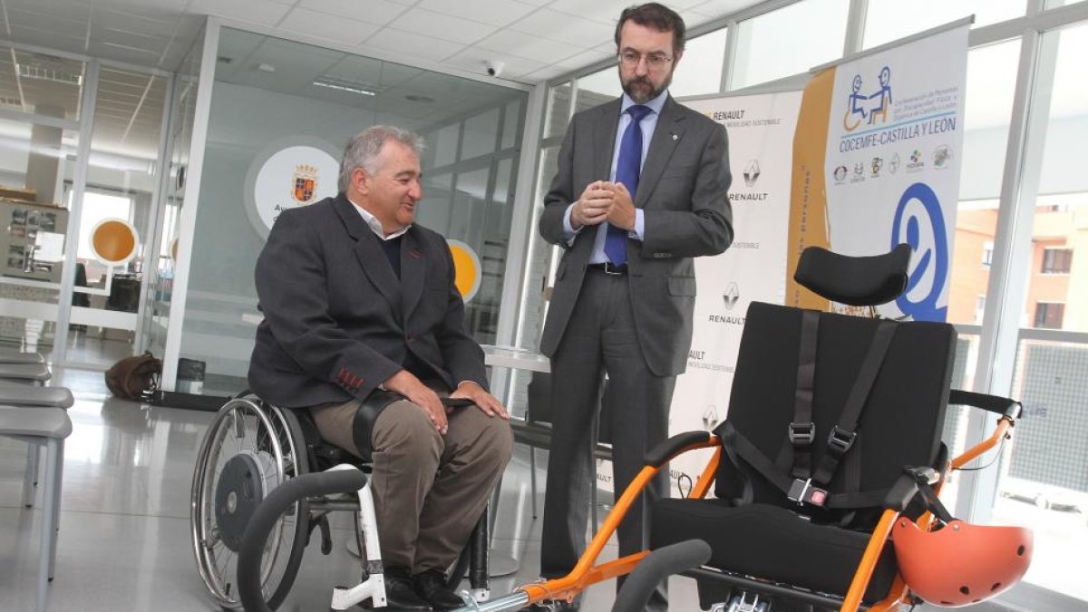 El director general de la Fundación Renault, Andrés Salas (D) y el presidente de COCEMFE de Castilla y León, José Antonio Fierro (I) antes de la firma de un convenio entre la Fundación Renault y Cocemfe Castilla y León junto a una joëlette que facilitará-Brágimo / ICAL