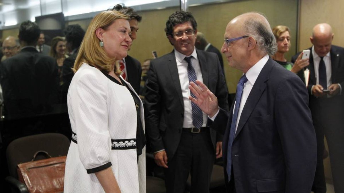 La consejera de Economía y Hacienda, Pilar del Olmo, saluda al ministro de Hacienda y Administraciones Públicas, Cristobal Montoro al comienzo de la reunión del Consejo de Política Fiscal y Financiera.-ICAL