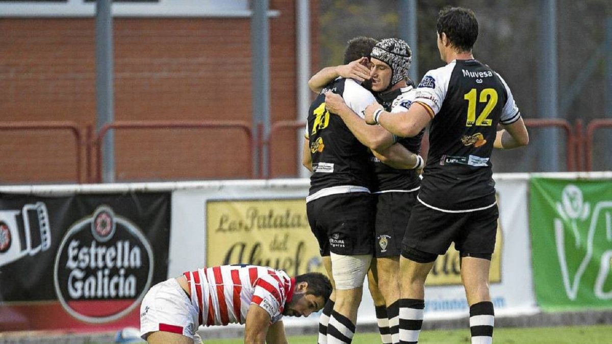 Carter, Núñez y Pearce celebran un ensayo del Hermi en el encuentro de ayer ante un jugador del Vigo postrado en el suelo-P. REQUEJO