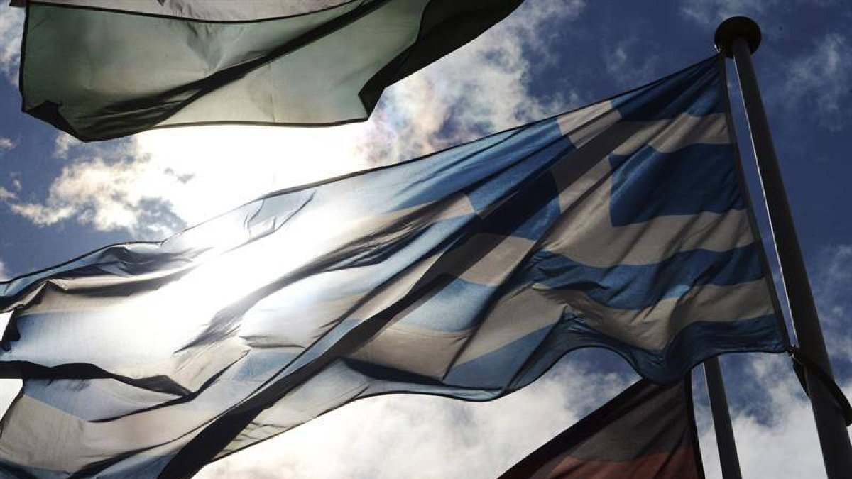 Un hombre bajo la bandera griega.-Foto: PATRICK SEEGER/ EPA