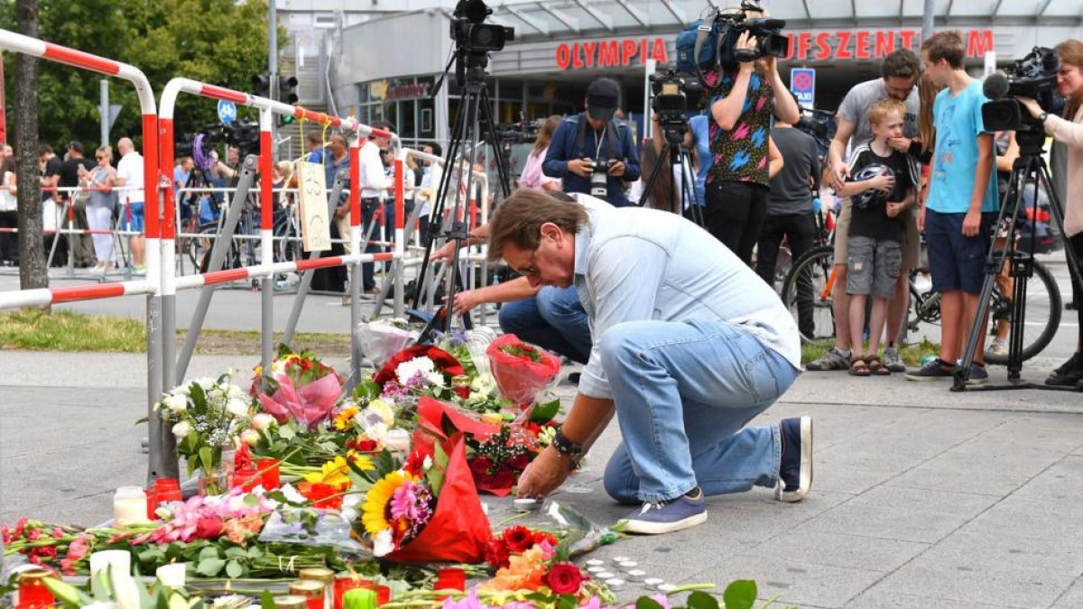 Un hombre deposita flores junto al lugar del ataque.-AFP