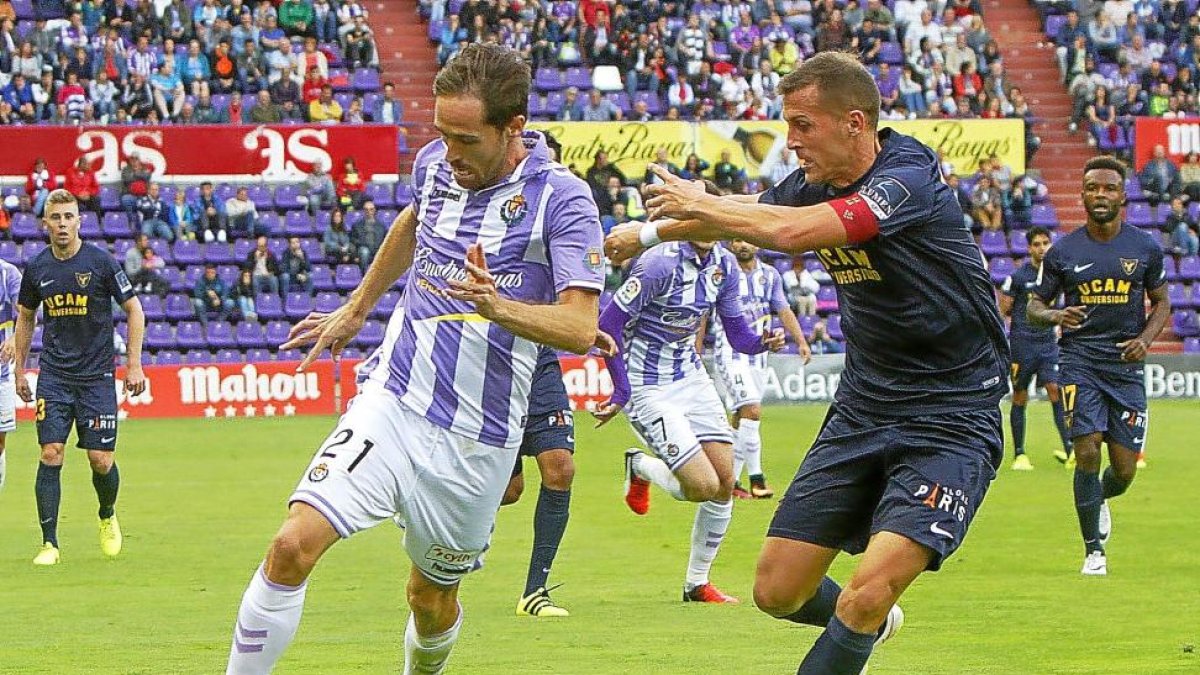 Míchel se lleva el balón ante la presencia de Góngora en el partido frente al UCAM Murcia.-J.M.LOSTAU