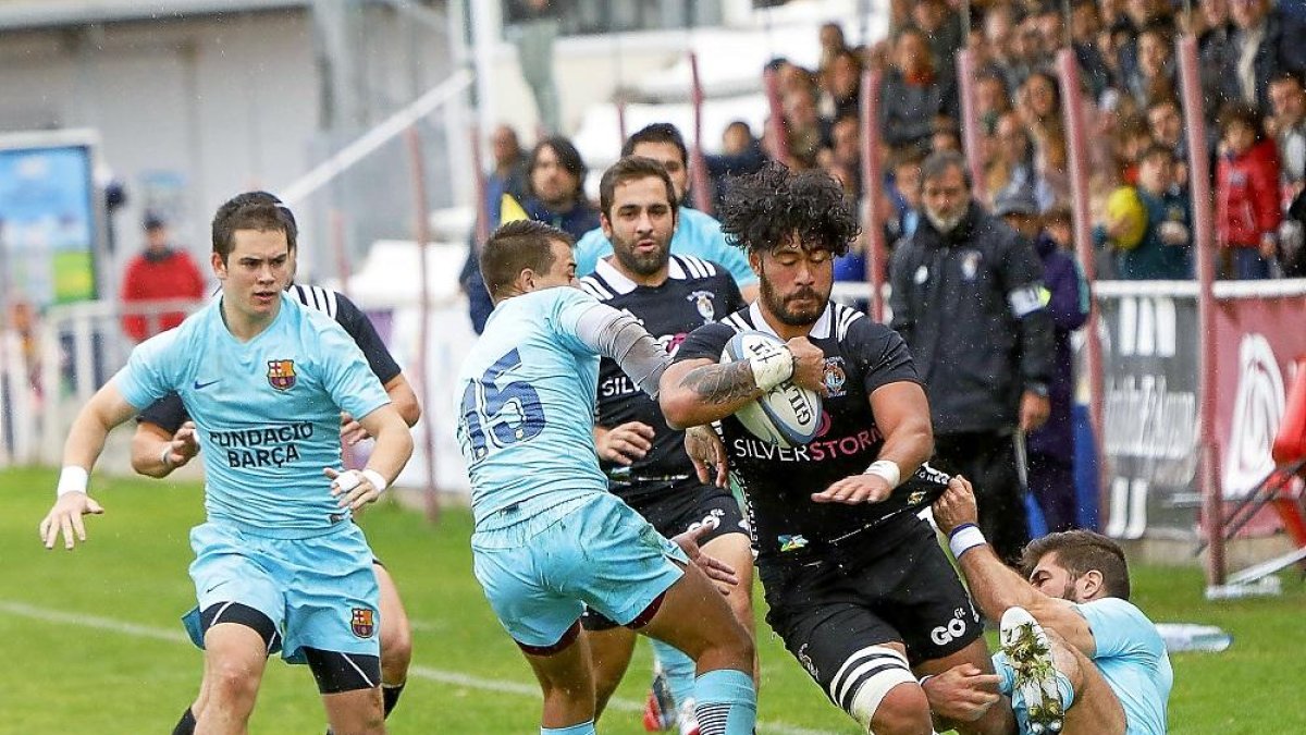 Nuu Junior evita el placaje de los jugadores del Barça Rugby en el partido disputado en Pepe Rojo.-J. M. LOSTAU