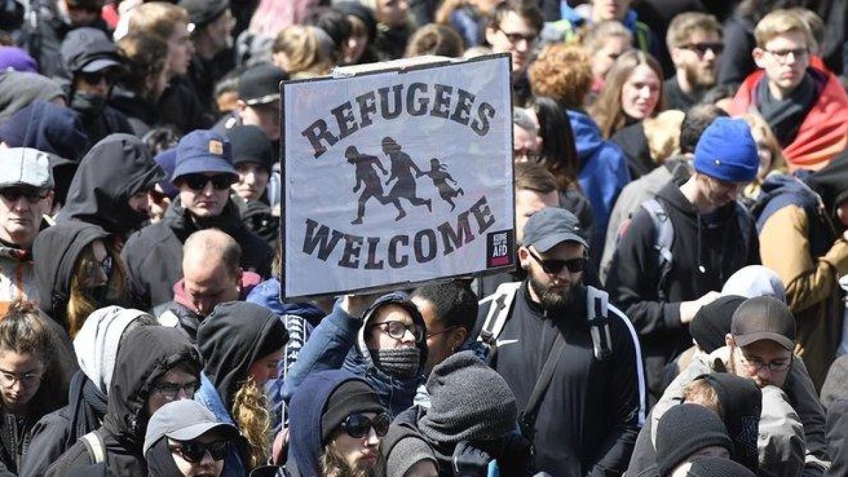 Manifestantes sostienen una pancarta de bienvenida a los refugiados, en una marcha en Colonia.-MARTIN MEISSNER (AP)