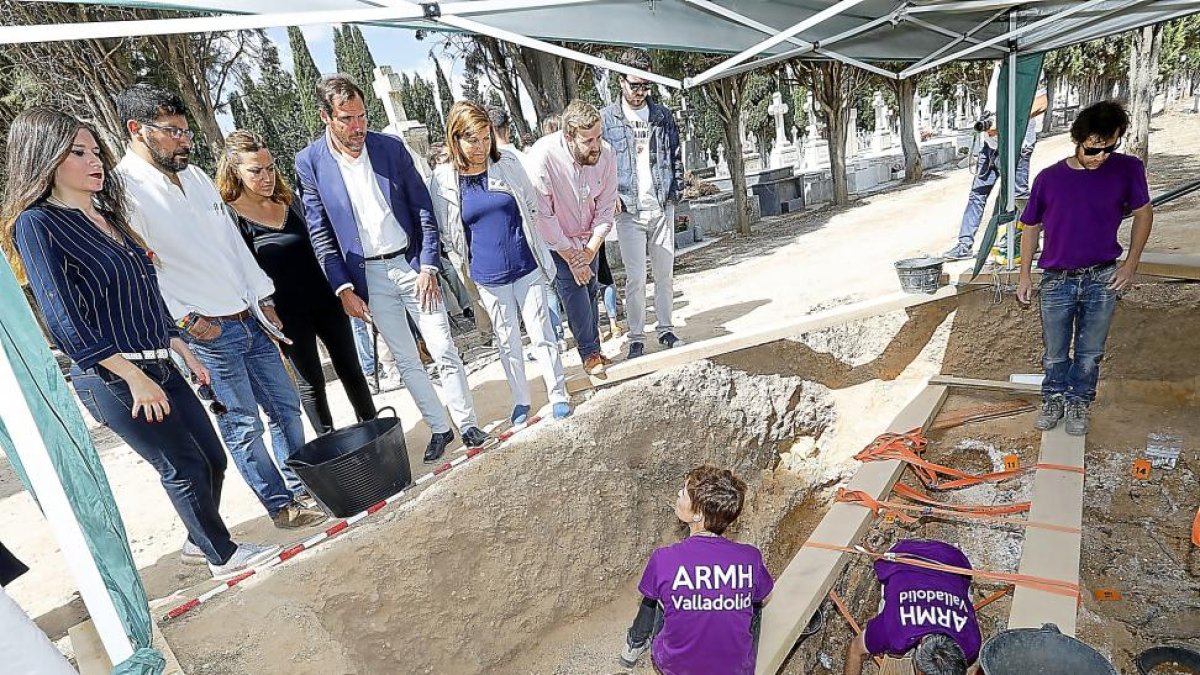 El alcalde de Valladolid, Óscar Puente, junto a algunos miembros del Gobierno municipal y del PSOE regional observando los trabajos en la fosa.-J.M. LOSTAU
