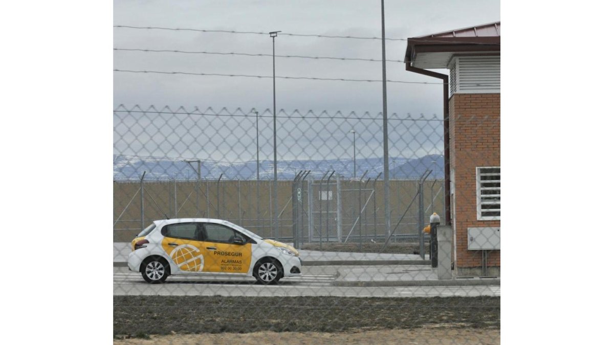 El coche de la empresa de seguridad apostado junto a la prisión.-VALENTÍN GUISANDE