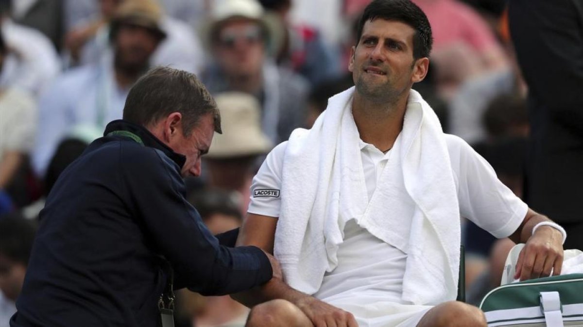 Djokovic recibe tratamiento en el codo en su partido ante Berdych en Wimbledon-AP / GARETH FULLER
