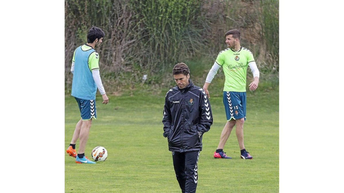 Rubi, pensativo, durante el entrenamiento ; al fondo, Valiente y Chus Herrero-Miguel Ángel Santos