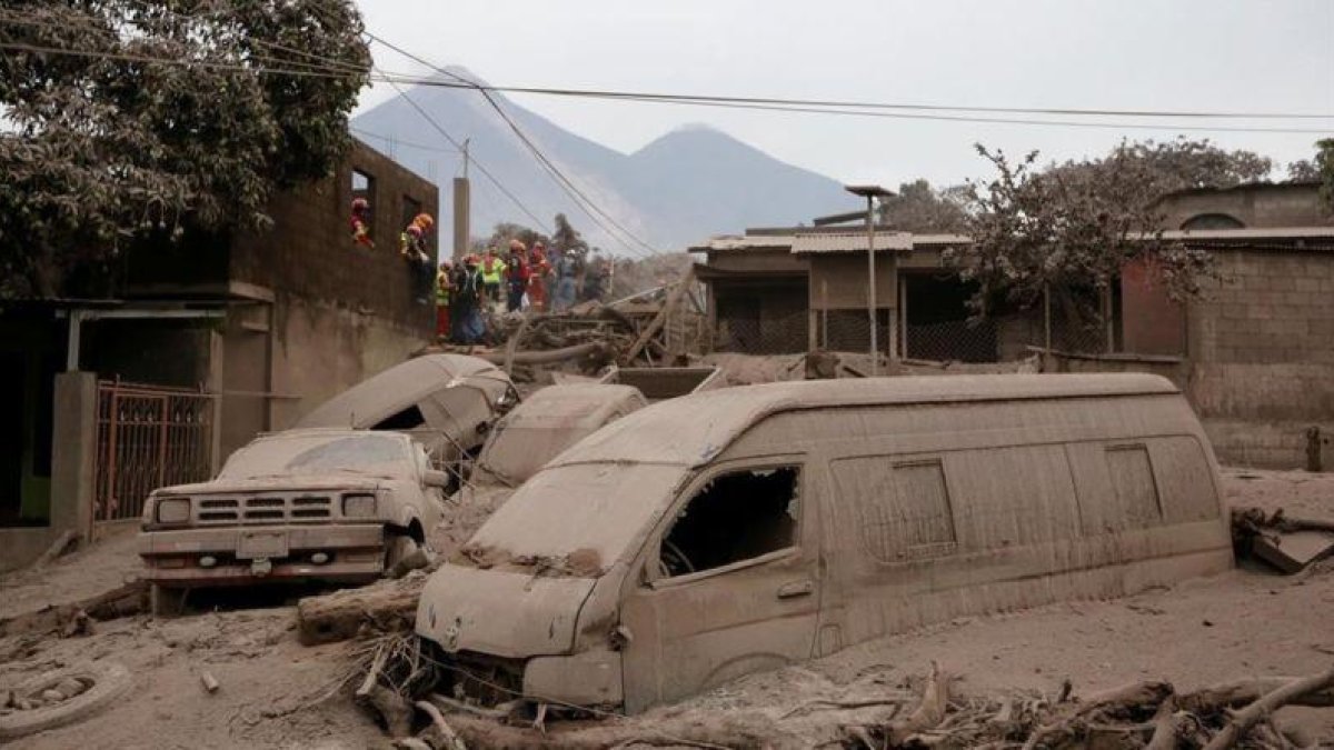 Bomberos y personal de rescate inspecciona los destrozos causados por el volcán de Fuego en Escuintla, Guatemala.-REUTERS (LUIS ECHEVERRÍA)