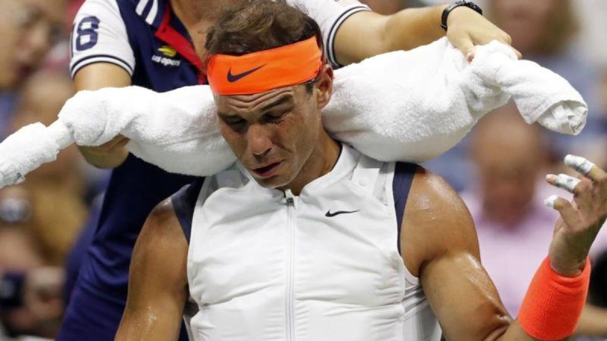 Una recogepelotas ayuda a Nadal a moverse con el chaleco de hielo-USA TODAY
