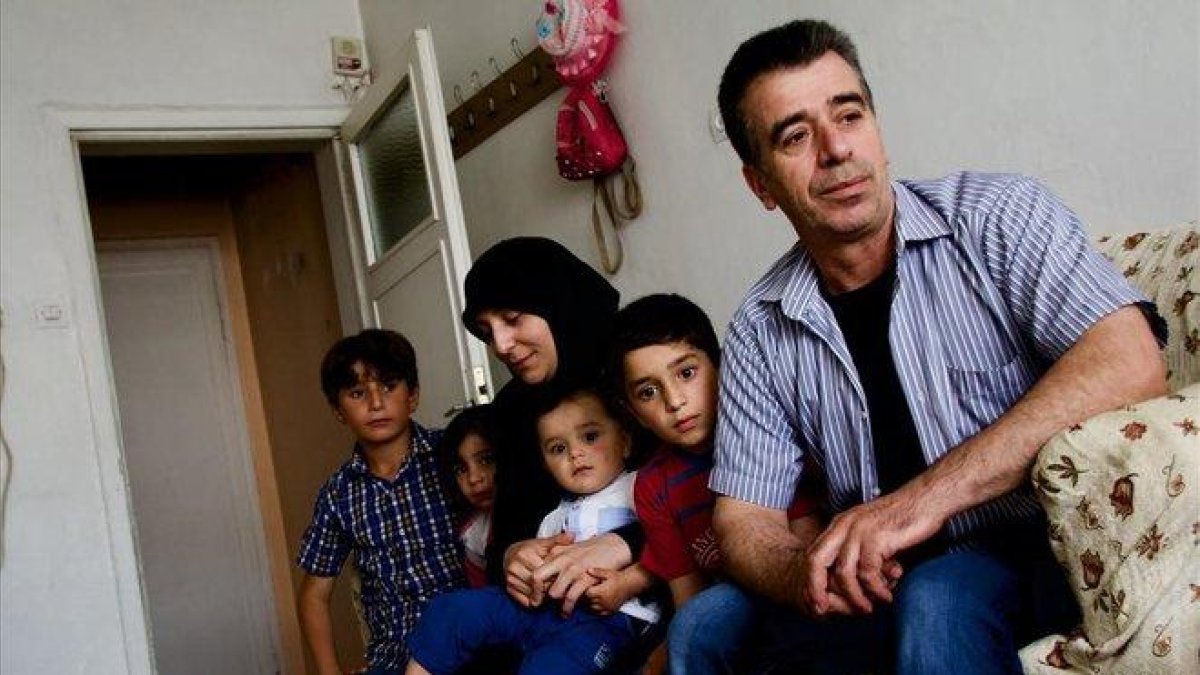 Musa y Murfat, con sus cuatro hijos, en el domicilio que viven en el barrio de Altindag, en las afueras de Ankara.-ADRIÀ ROCHA CUTILLER