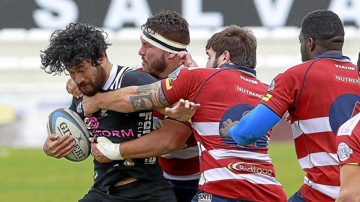 Dos jugadores de La Vila intentan frenar el ataque de Nuu Junior.-J. M. LOSTAU