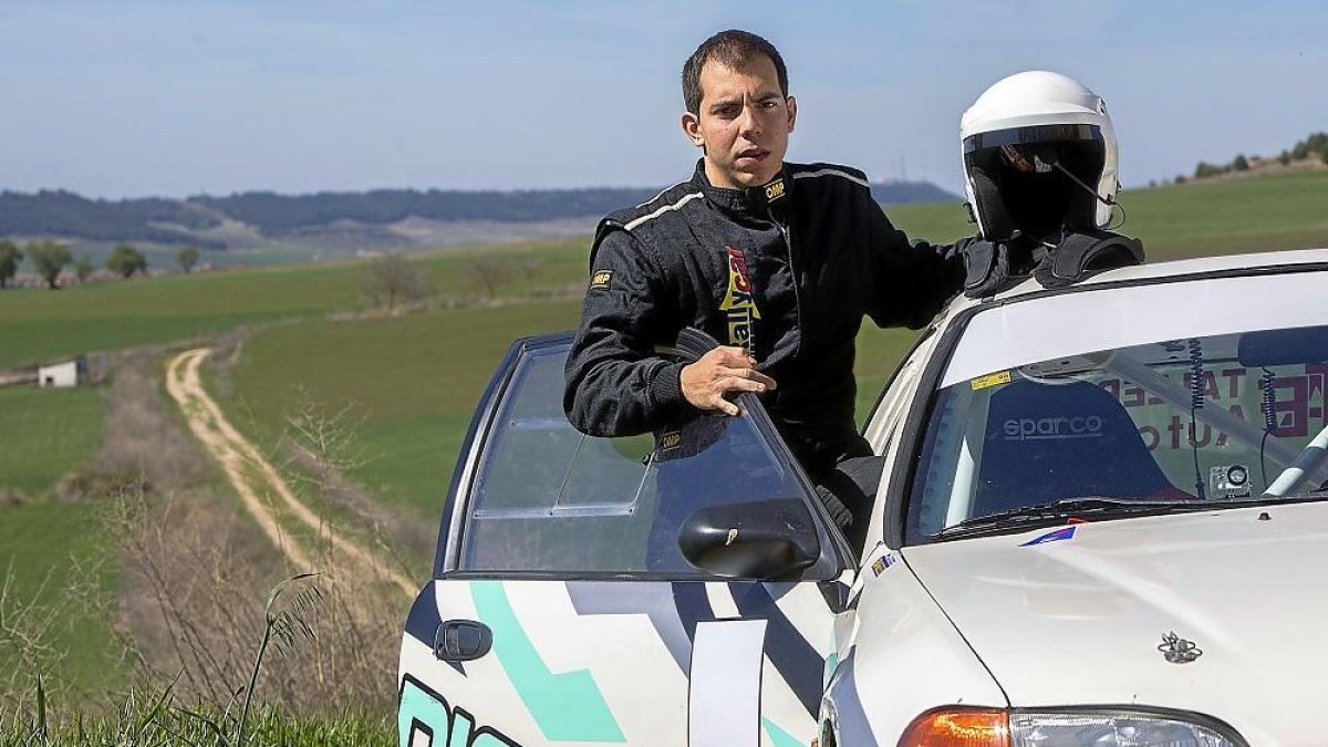 El piloto posa con el Honda Civic con el que compite en la localidad de Castronuevo de Esguega.-J. M. LOSTAU
