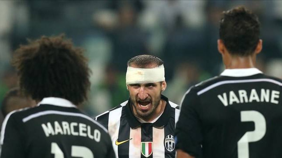 Chiellini arenga a sus compañeros ante Marcelo y Varane, en la ida en Turín.-Foto:   AFP / MARCO BERTORELLO