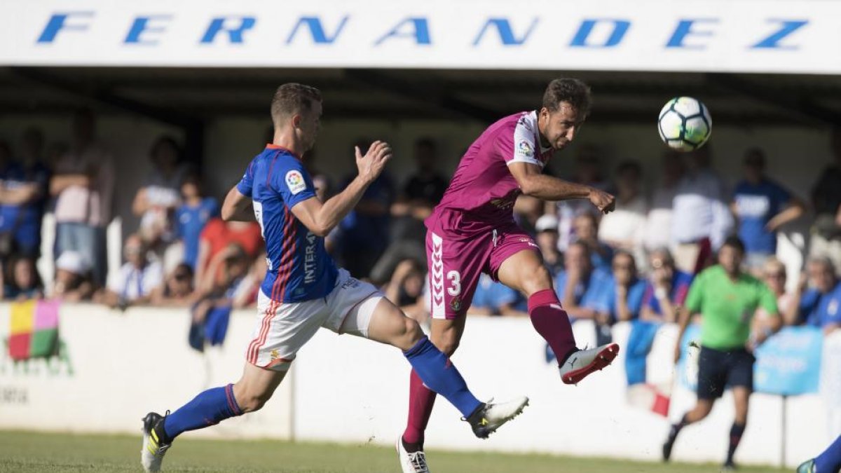 Ángel chuta ante la presencia de un jugador del Oviedo en el partido disputado ayer en Luarca.-DAVID S. BUSTAMANTE