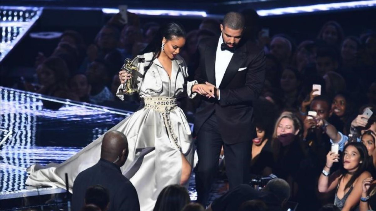 Drake acompaña a Rihanna después de que la cantante recibiera un premio.-AFP / JEWEL SAMAD
