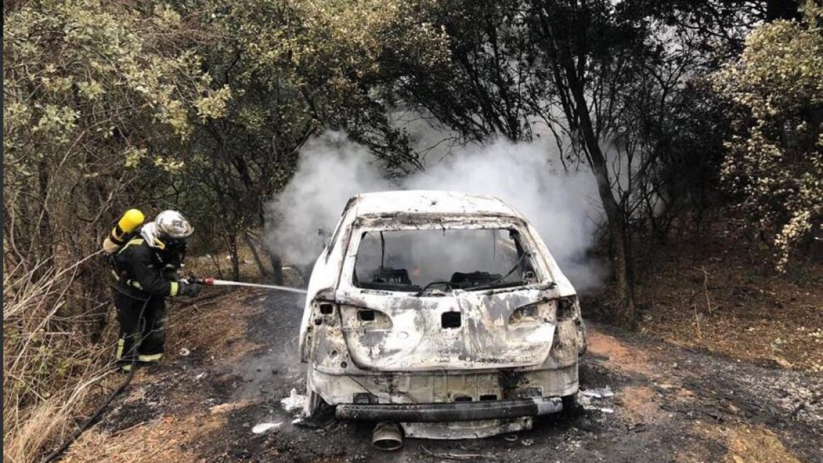 Bomberos sofocando el fuego del vehículo calcinado.-Imagen escogida de la cuenta de Twitter @BomberosVLL