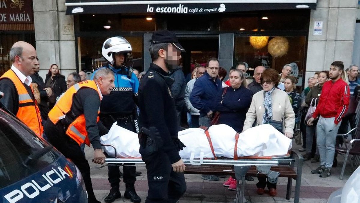 Operarios del servicio forense trasladan el cuerpo de Mari el pasado jueves, custodiados por policías.-J.M. LOSTAU