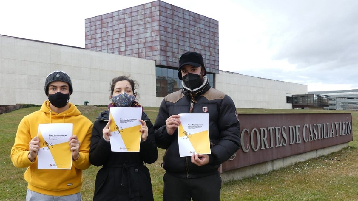 Tres integrantes del colectivo Jóvenes Castilla y León posan con las aportaciones para el anteproyecto de Ley de Dinamización Demográfica de CyL. E.M