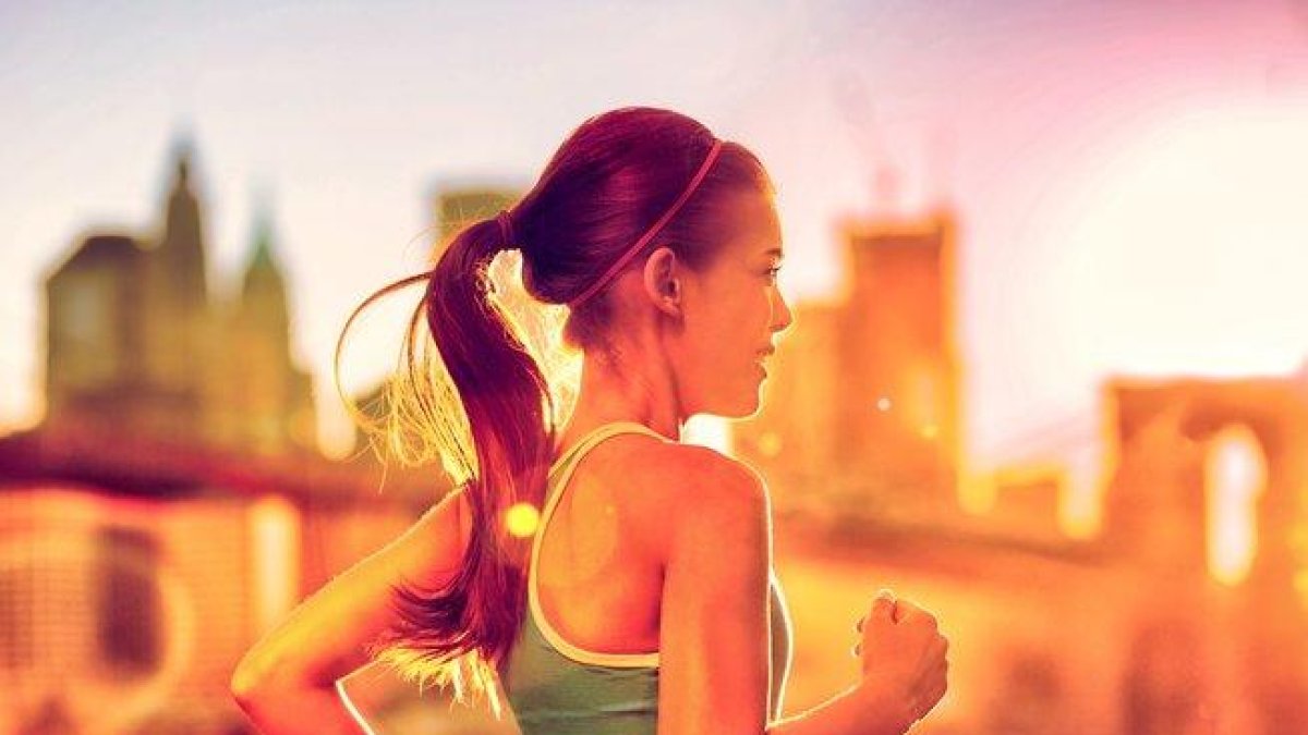Una chica practicando running.-123RF / MARIDAV