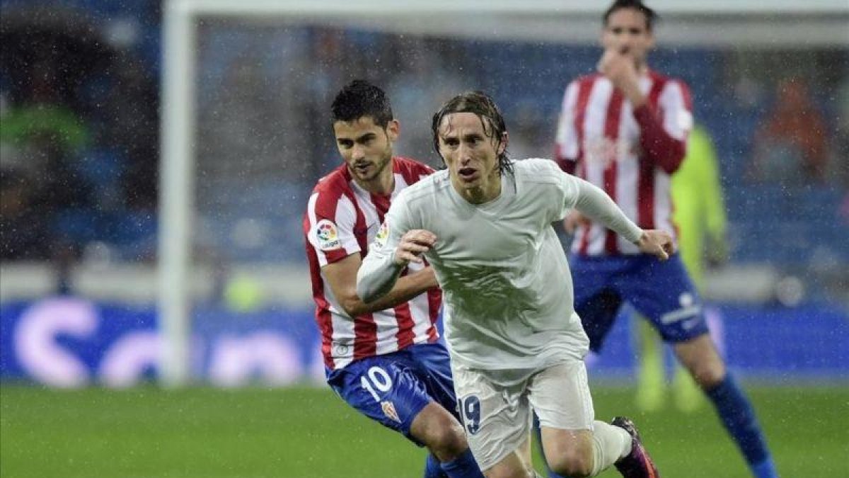 Luka Modric se va de Nacho Cases durante el partido contra el Sporting del sábado pasado en el Bernabéu.-AFP / JAVIER SORIANO