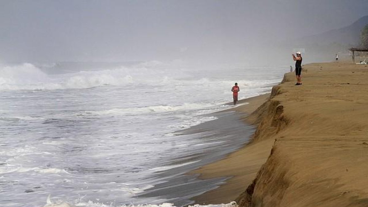 Un hombre toma fotografías del huracán 'Patricia' desde la playa de Acapulco, México.-REUTERS / STRINGER