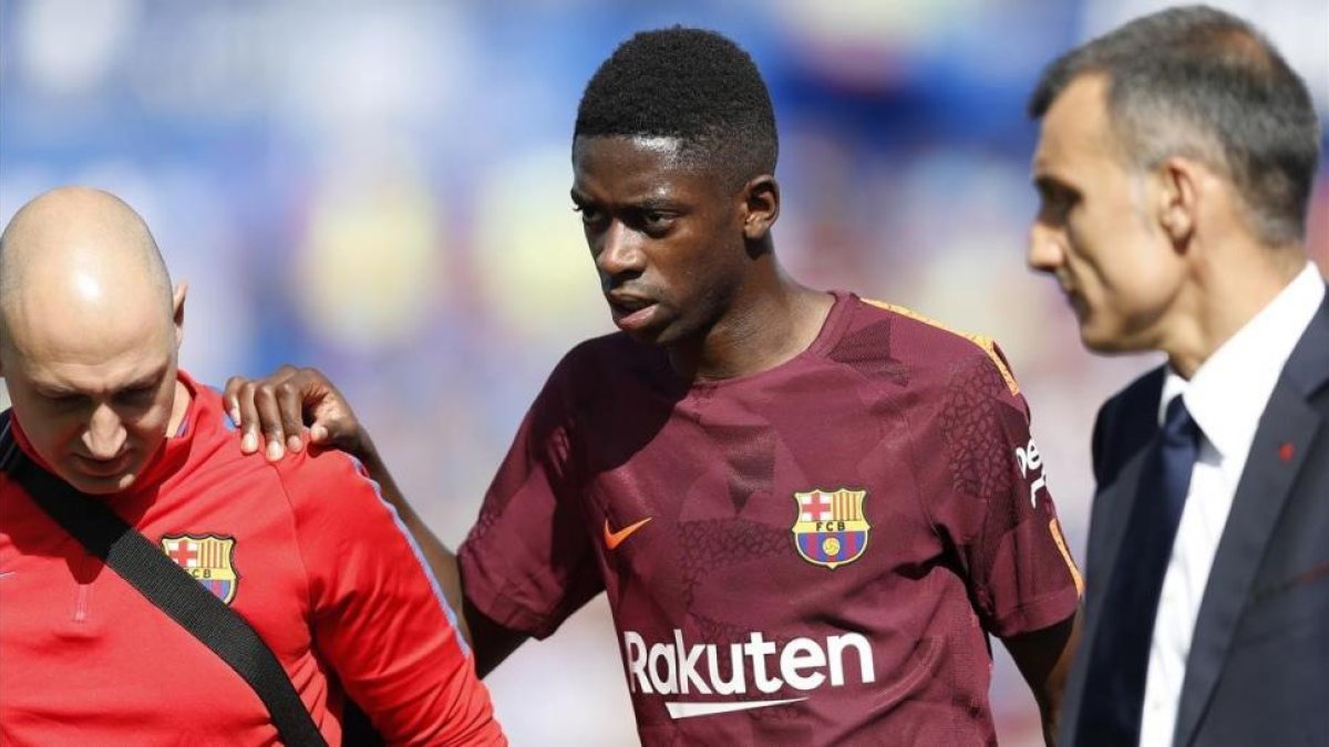 Dembéle abandona lesionado el campo del Getafe.-AP