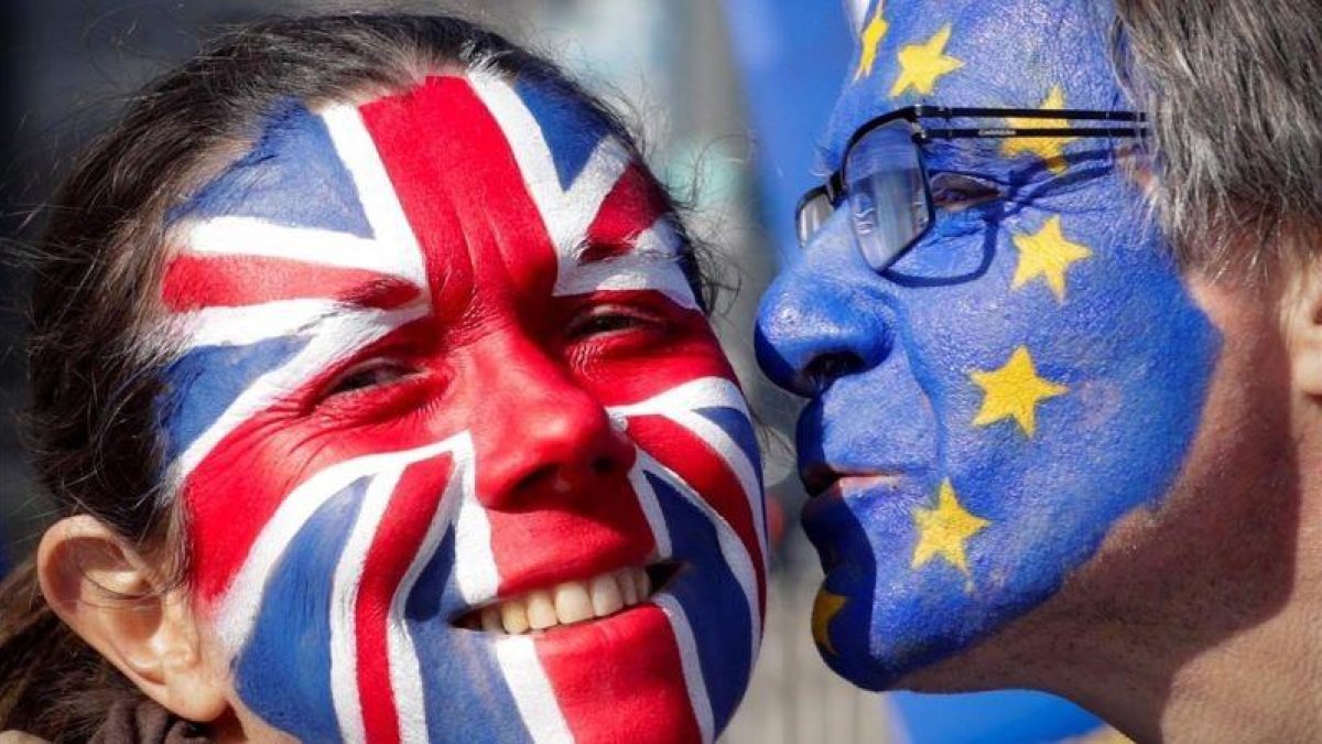 Dos activistas con las caras pintadas con la bandera británica y la de la Unión Europea participan en una manifestación contra el  brexit en Bruselas.-EFE / OLIVIER HOSLET