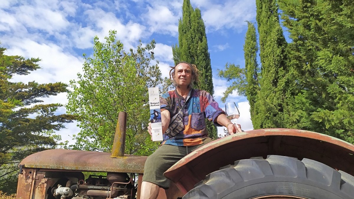 Epifanio García, con una muestra de su Maiquel Jackson, subido al viejo tractor de la bodega en Olivares de Duero.