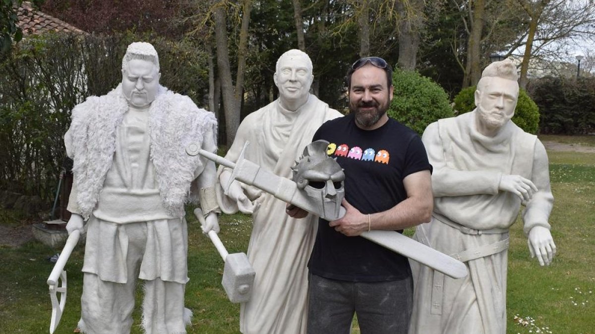 El escultor Alberto del Campo posa con tres de sus obras en el jardín de su taller, en Tudela de Duero (Valladolid).-