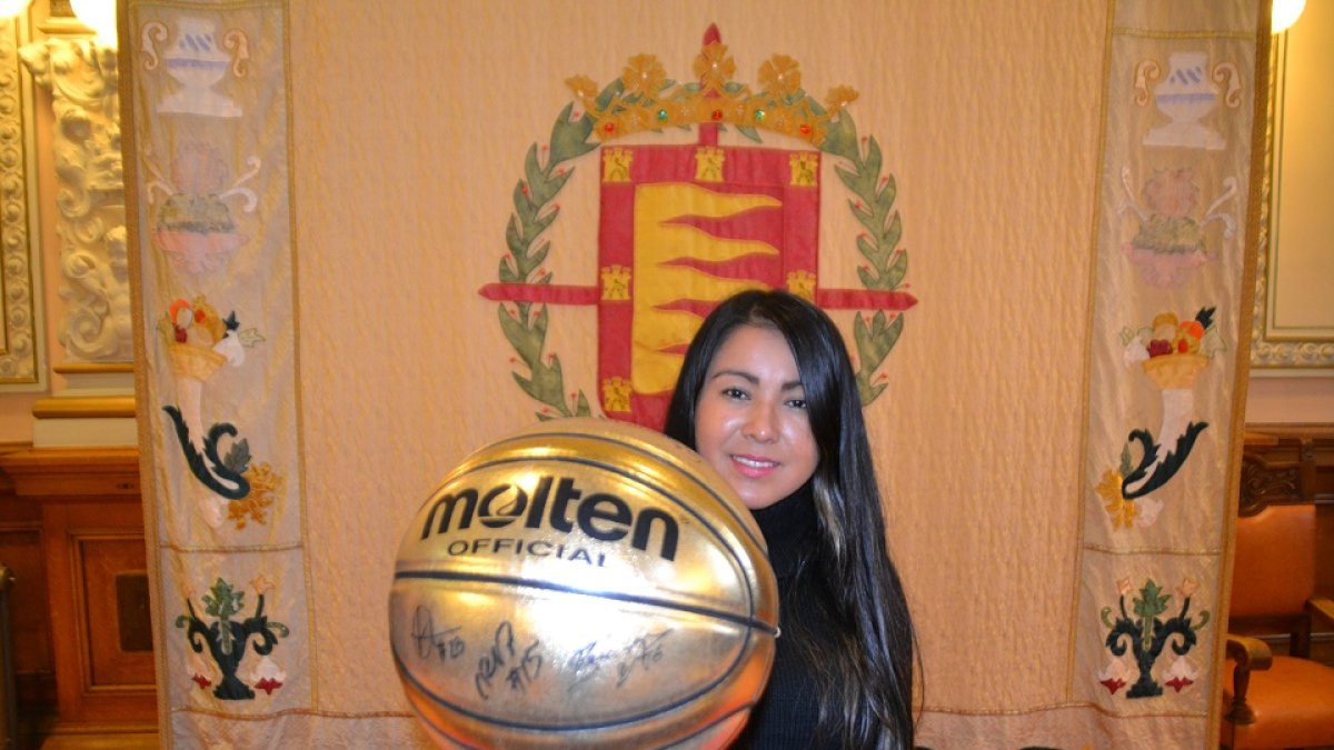 Glendy Carrero sostiene un balón de baloncesto en la sala de recepciones del Ayuntamiento de Valladolid. D. M.