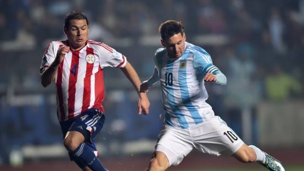 El jugador argentino, Lionel Messi, junto al defensa del Paraguay, Pablo Cesar Aguilar.-Foto: YURI CORTEZ / AFP