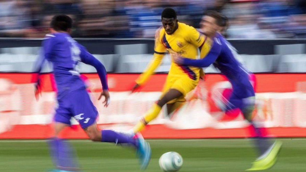 Dembelé trata de irse de dos jugadores del Leganés.-EFE / RODRIGO JIMÉNEZ