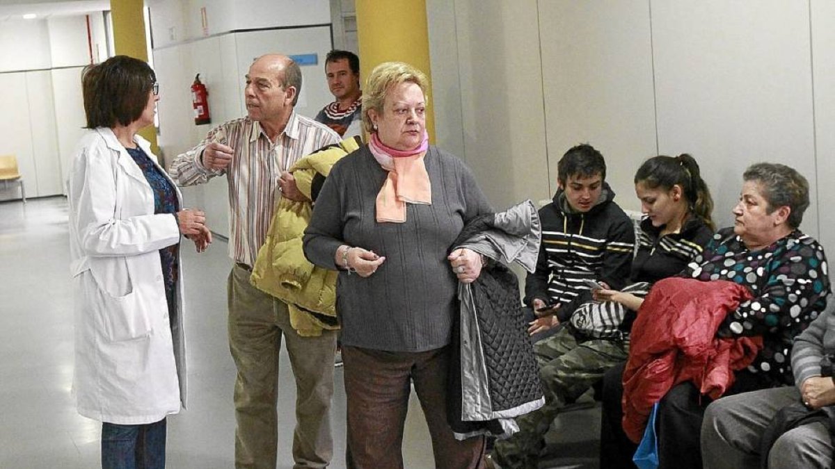 Un paciente conversa con una facultativo del centro de salud de Canterc, en Las Delicias, mientras otros pacientes esperan su turno-J.M.Lostau