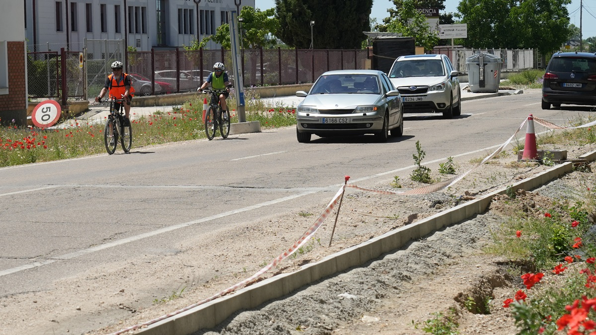 Ciclistas circulando por el arcén del camino viejo de Simancas porque la construcción del carril bici está paralizada.