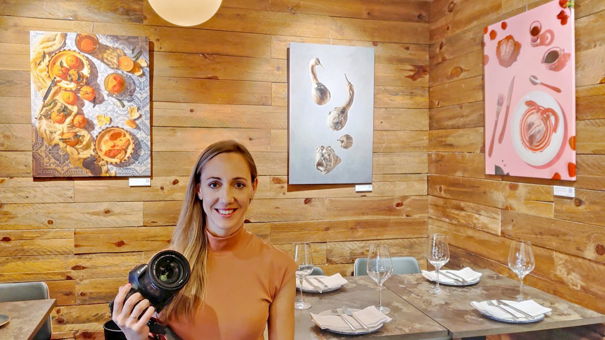 La fotógrafa gastronómica Alba García posa frente a su exposición Gastro Arte, en el local Barrio Húmedo de Madrid.