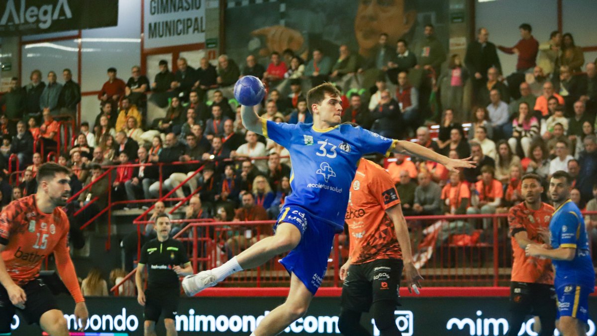 Pablo Herrero vuela y arma el brazo antes de lanzar tras superar la defensa del BM Torrelavega.