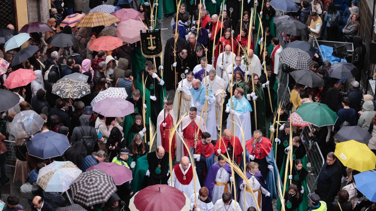 Procesión del Domingo de Ramos con el paso de la borriquilla bajo los paraguas