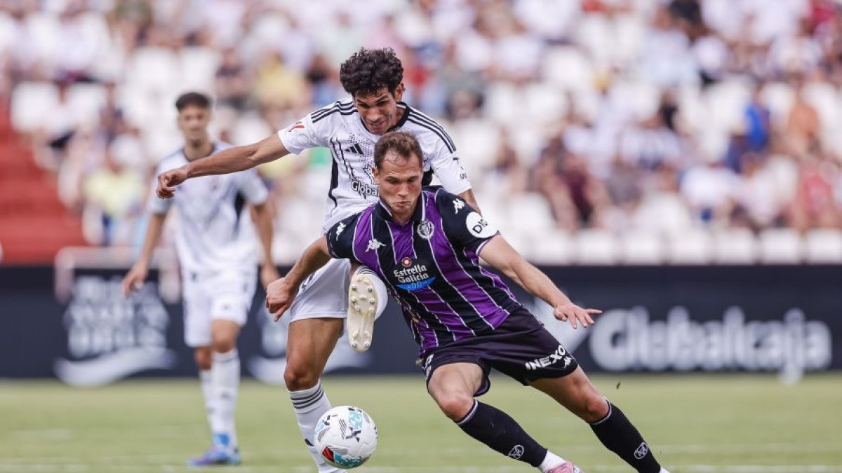 Latasa intenta evitar el marcaje de Vallejo.