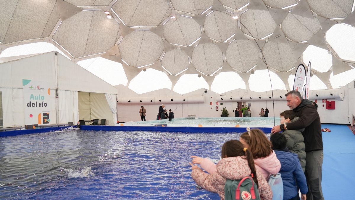 Unos niños aprenden a pescar en la Cúpula del Milenio.