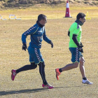 Óscar corre con el balón perseguido por su compañero Peña, durante el entrenamiento del lunes-Pablo Requejo